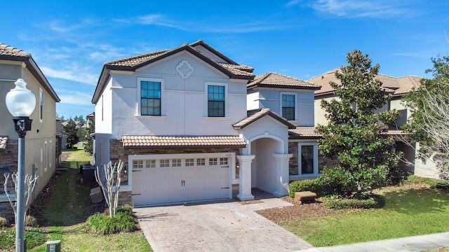 view of front of property featuring a front yard and a garage