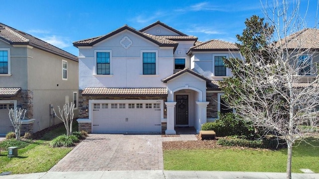 view of front of house with a front yard and a garage