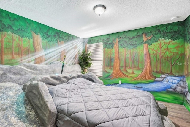 bedroom with hardwood / wood-style flooring and a textured ceiling