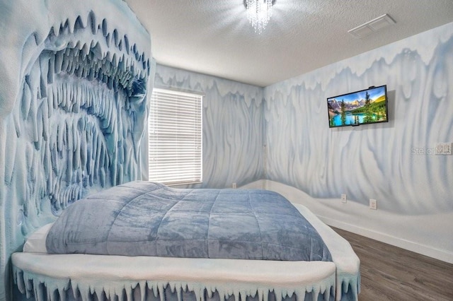 bedroom featuring dark wood-type flooring and a textured ceiling