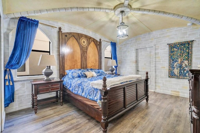 bedroom featuring hardwood / wood-style flooring and vaulted ceiling