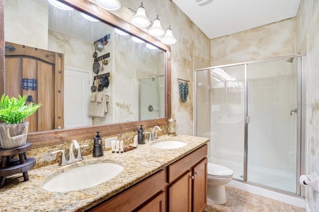 bathroom with toilet, vanity, tile patterned floors, and an enclosed shower