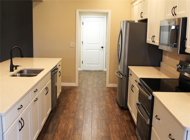 kitchen featuring white cabinetry, sink, dark wood-type flooring, and appliances with stainless steel finishes