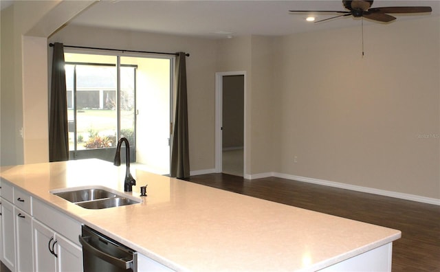 kitchen with dishwasher, white cabinetry, sink, and a kitchen island with sink