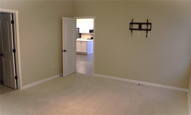 spare room with light colored carpet