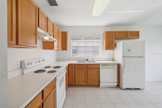 kitchen with white appliances, sink, and light tile patterned flooring