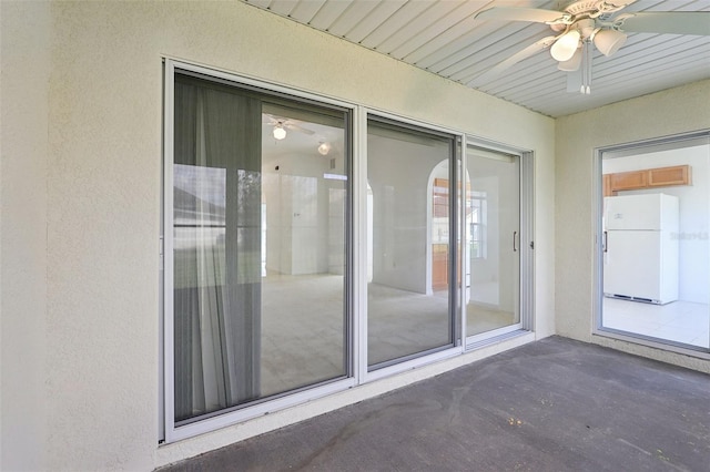 exterior space with ceiling fan