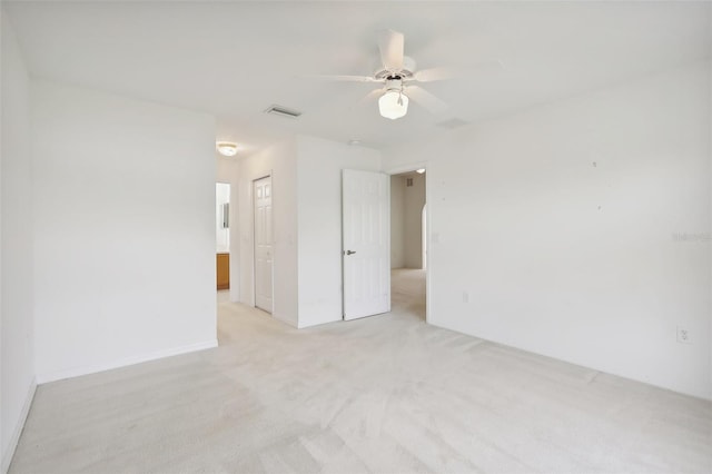 unfurnished room featuring light carpet and ceiling fan