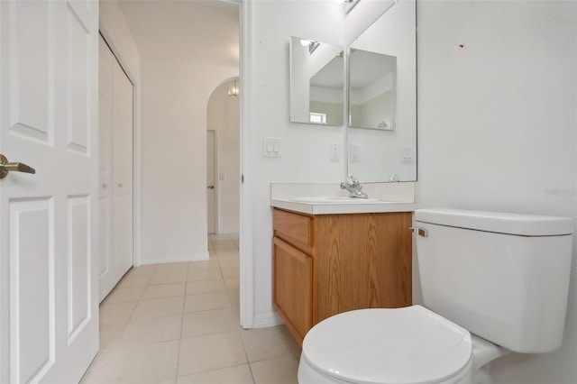 bathroom featuring tile patterned flooring, vanity, and toilet