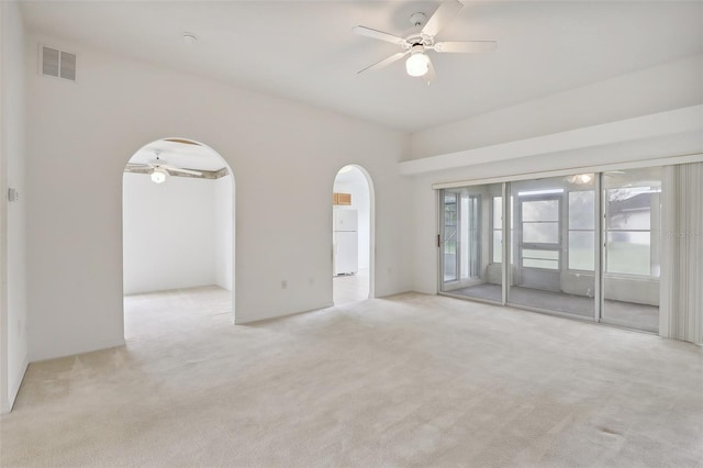 unfurnished room with ceiling fan and light colored carpet