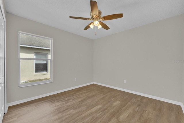 unfurnished room featuring hardwood / wood-style flooring and ceiling fan