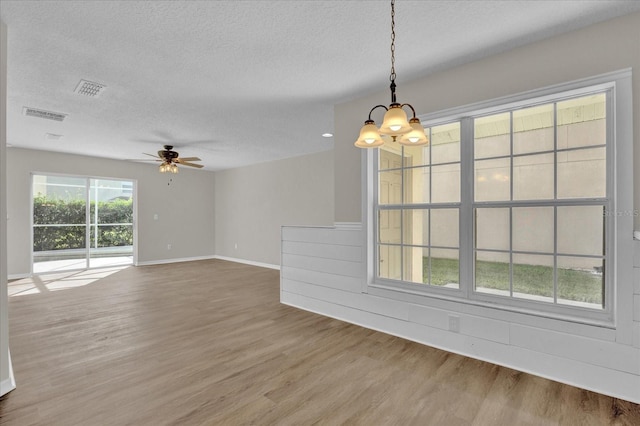 interior space with hardwood / wood-style flooring, ceiling fan, and a textured ceiling