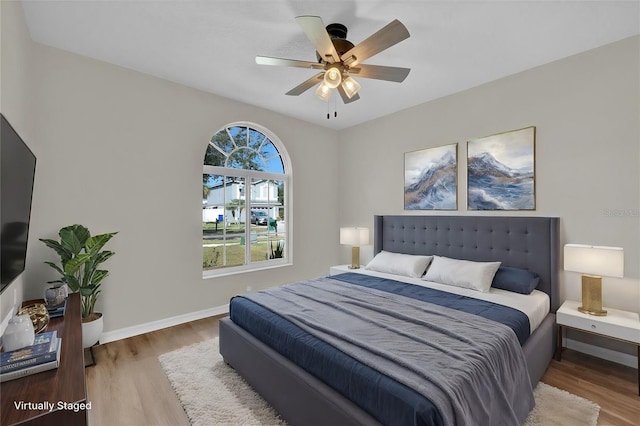 bedroom with hardwood / wood-style floors and ceiling fan