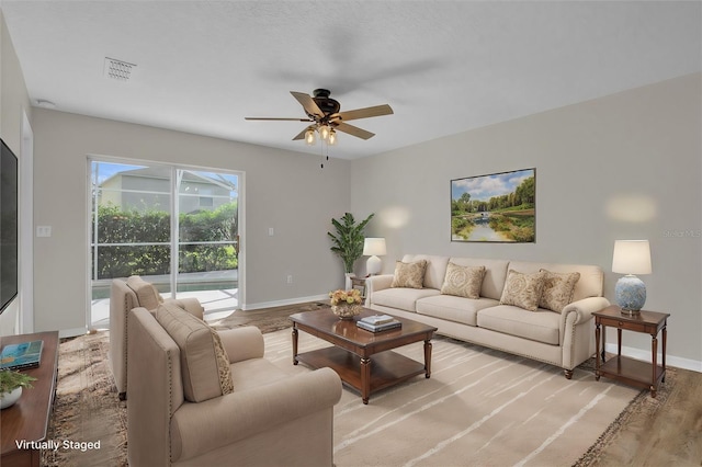 living room featuring ceiling fan and light wood-type flooring