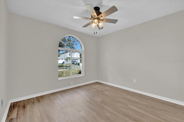 unfurnished room with hardwood / wood-style flooring, a textured ceiling, and ceiling fan