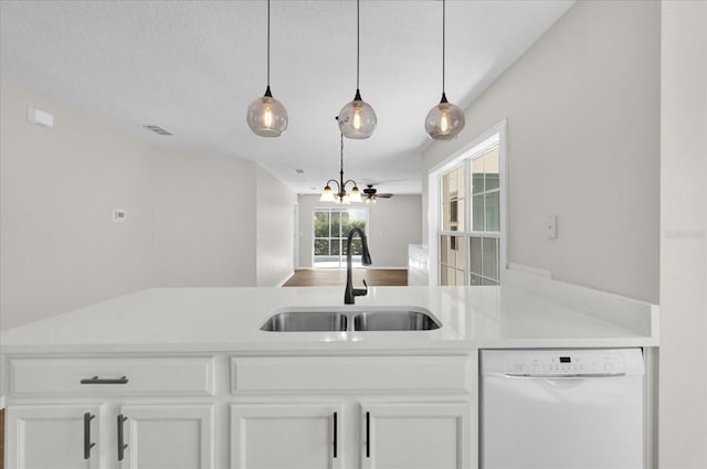 kitchen featuring sink, white cabinetry, hanging light fixtures, white dishwasher, and a notable chandelier