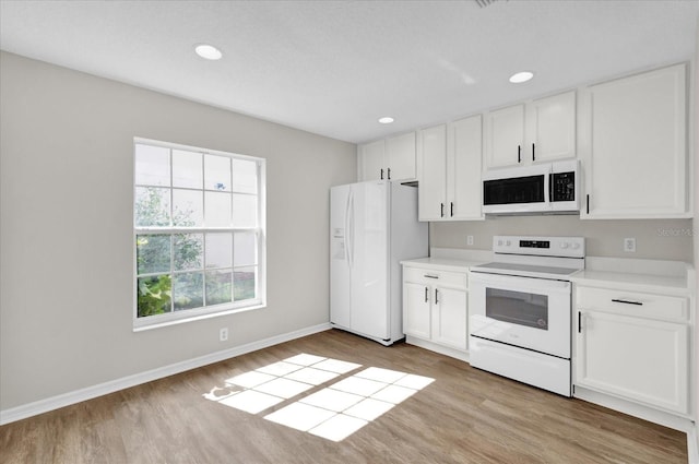 kitchen featuring white cabinetry, white appliances, and light wood-type flooring