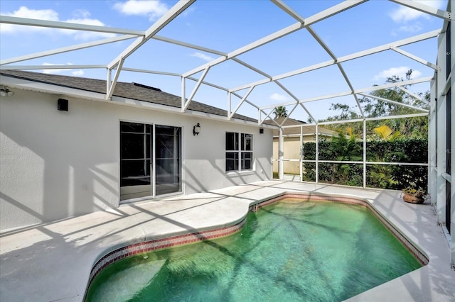 view of swimming pool with a lanai and a patio area