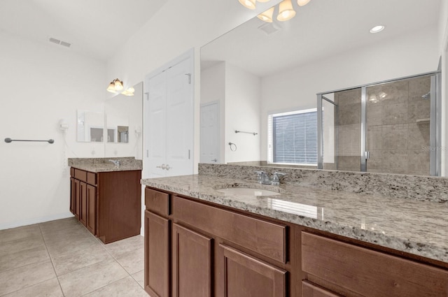 bathroom featuring vanity, tile patterned floors, and an enclosed shower