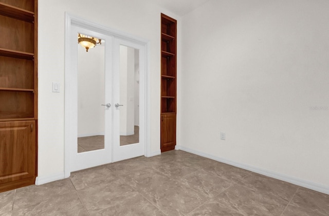 unfurnished bedroom featuring french doors and light tile patterned floors