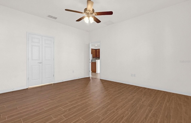 unfurnished room featuring dark hardwood / wood-style floors and ceiling fan