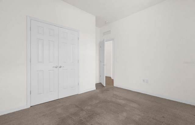 unfurnished bedroom with carpet floors and a closet