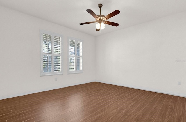 empty room featuring ceiling fan and dark hardwood / wood-style floors