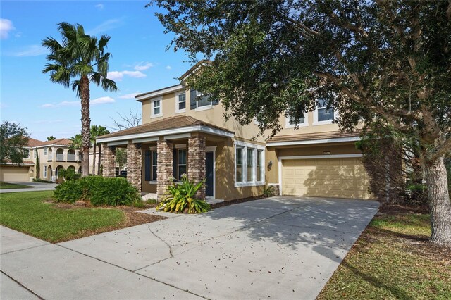4204 Oakview Dr, Davenport, FL 33837 - view of front of house featuring stucco siding, stone siding, an attached garage, and concrete driveway