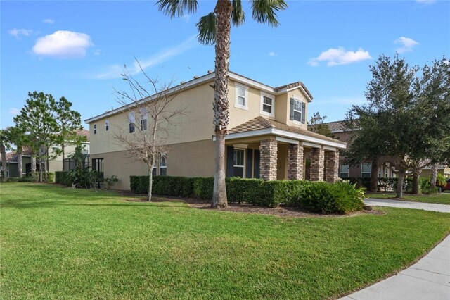 4204 Oakview Dr, Davenport, FL 33837 - view of property exterior with a lawn, stucco siding, a tiled roof, and stone siding