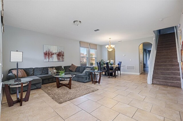 4204 Oakview Dr, Davenport, FL 33837 - living area featuring arched walkways, stairs, a chandelier, light tile patterned floors, and baseboards