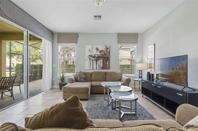 4204 Oakview Dr, Davenport, FL 33837 - living room featuring light tile patterned flooring, plenty of natural light, and baseboards