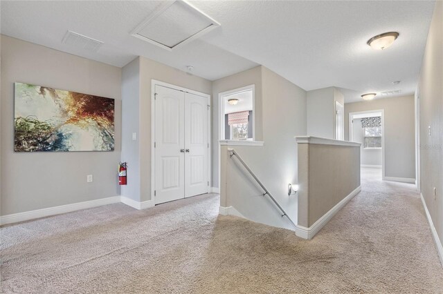 4204 Oakview Dr, Davenport, FL 33837 - hallway with an upstairs landing, carpet, baseboards, and attic access