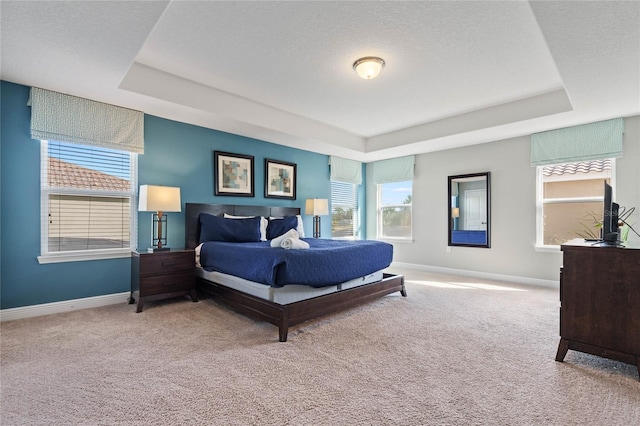 4204 Oakview Dr, Davenport, FL 33837 - carpeted bedroom with a tray ceiling and baseboards