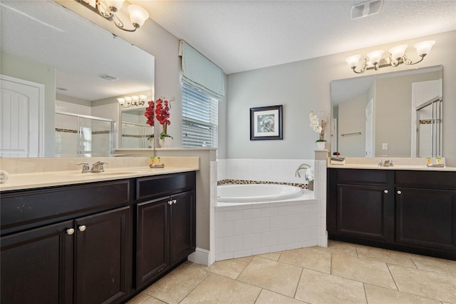 bathroom with shower with separate bathtub, vanity, a textured ceiling, and tile patterned floors