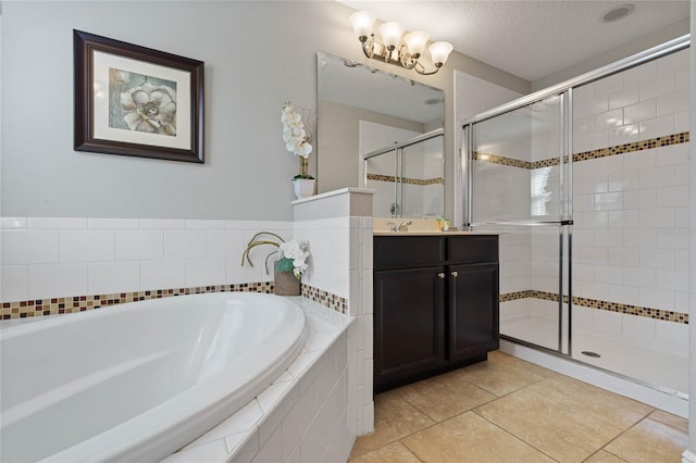 bathroom featuring vanity, a textured ceiling, tile patterned floors, and independent shower and bath