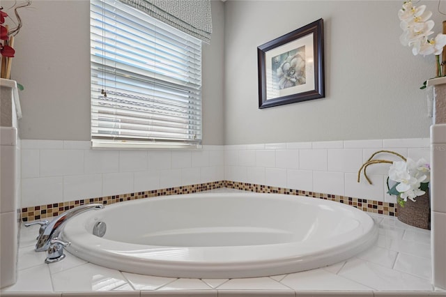 bathroom featuring tiled tub