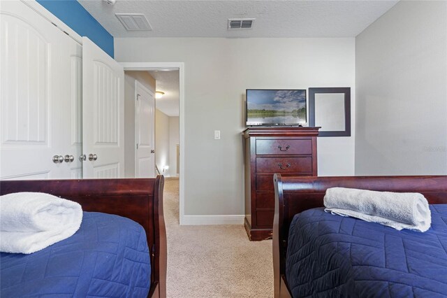 4204 Oakview Dr, Davenport, FL 33837 - bedroom with light colored carpet, baseboards, a textured ceiling, and a closet