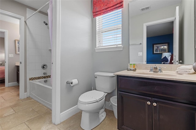 full bathroom featuring vanity, toilet, and tiled shower / bath