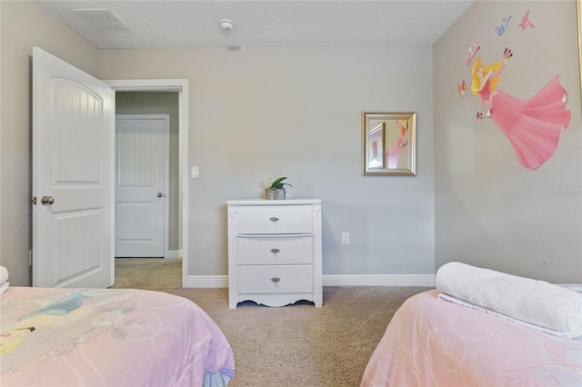 bedroom featuring a textured ceiling and light colored carpet