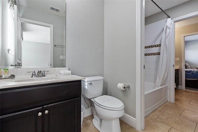 4204 Oakview Dr, Davenport, FL 33837 - bathroom featuring toilet, vanity, shower / tub combo with curtain, and baseboards
