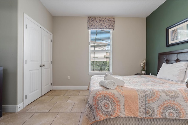 tiled bedroom featuring a closet