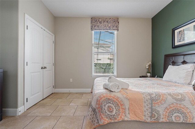 4204 Oakview Dr, Davenport, FL 33837 - bedroom with baseboards and light tile patterned floors