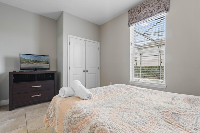 tiled bedroom featuring a closet