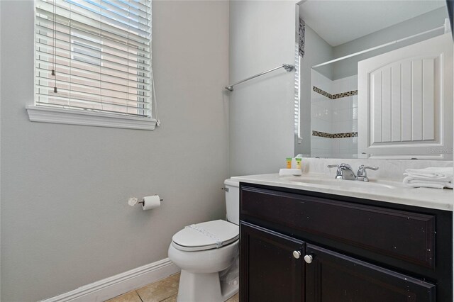 4204 Oakview Dr, Davenport, FL 33837 - full bathroom with toilet, vanity, baseboards, tile patterned floors, and a shower