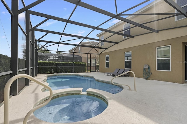 view of swimming pool with a patio, a lanai, and an in ground hot tub