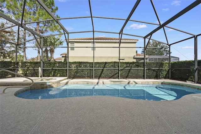 view of swimming pool featuring glass enclosure and a patio area