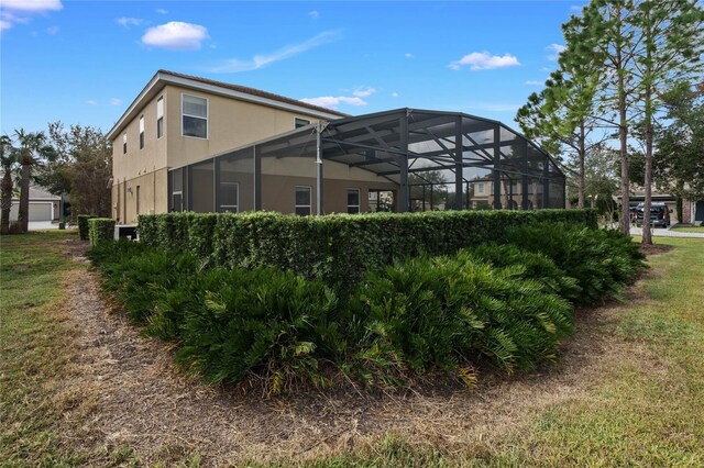 4204 Oakview Dr, Davenport, FL 33837 - back of property featuring stucco siding and glass enclosure
