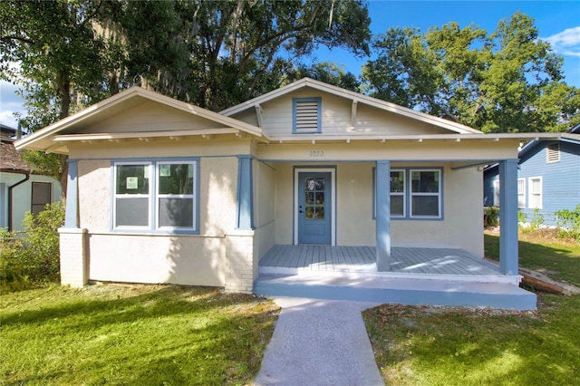 bungalow-style house with a porch and a front lawn