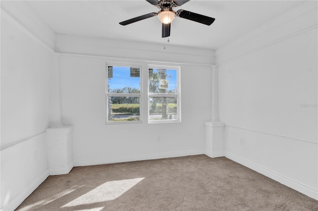 carpeted spare room featuring ceiling fan