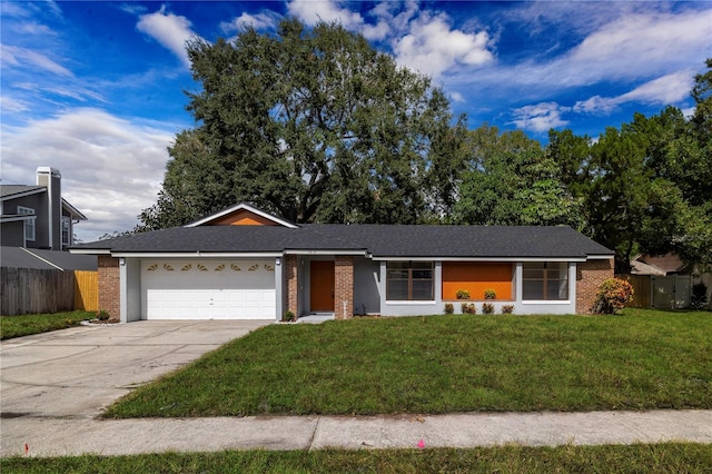 single story home featuring a garage and a front yard